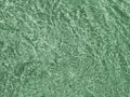 Green ripples of light reflect through shallow water on a sunny day Royalty Free Stock Photo