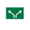 Green Road Sign with White Arrows Indicating Diverging Paths Royalty Free Stock Photo