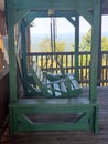 Green Rocking Chair on Isolated Mountain Cabin Royalty Free Stock Photo