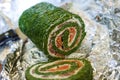 Green roll with fish in foil close up Royalty Free Stock Photo