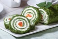 Green roll of spinach and cream cheese slices