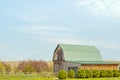 Green roof barn on blue sky day in Spring Royalty Free Stock Photo