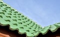 Green roof tile pattern over blue sky Royalty Free Stock Photo