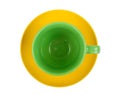 Green round empty tea cup on a yellow saucer Royalty Free Stock Photo