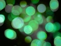 Green round glowing bright light abstract lights on a black background
