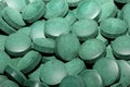 Green round healthy pills macro medical spirulina platensis space food modern high quality instant prints tablets background top