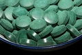 Green round healthy pills macro medical spirulina platensis space food modern high quality instant prints tablets background top