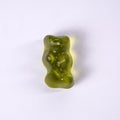 Green rubber bear candy on a white background