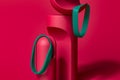 Green Rubber Bracelets on Abstract Figure On Pink Background. Silicone Wrist Bands With Empty Space. 3d Rendering