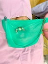 Green rubber dam isolation on tooth with metal clamp for dental filling procedure