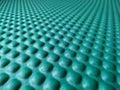 Green rubber mat texture closeup inside a gym. Perspective view of fitness floor background with copy space