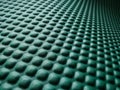 Green rubber mat texture inside a gym. Perspective view of fitness floor background with copy space