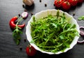 Rucola fresh salad in white bowl on dark wooden background Royalty Free Stock Photo