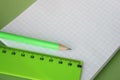 A green ruler and a pencil are located on the notebook. Copy Space.