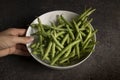 Green runner beans on dark background