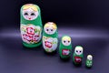 Green russian national Matrioska toy on dark background