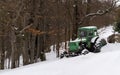 Green rustic old tractor in snowy weather Royalty Free Stock Photo