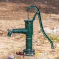 Green rusty manual water pump
