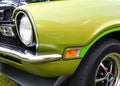 Closeup of a green 1970`s muscle car front end Royalty Free Stock Photo