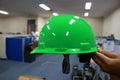 Green safety helmet complete with suspension and chin strap