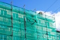 Green safety net on scaffolding at the facade of an apartment house Royalty Free Stock Photo