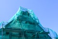 Green safety net on scaffolding in the restoration of a historic house Royalty Free Stock Photo