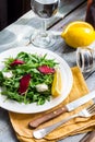 Green salad with arugula beet and goat cheese, lemon, organic fo