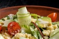 Green salad with couscous, avocado and tomato.