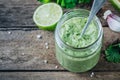 Green salad dressing with avocado, lime and cilantro in a glass jar Royalty Free Stock Photo
