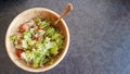 A green salad with lettuce, rice, tomatoes and olives