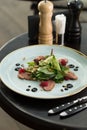 Green salad with pine nuts, meat and raspberry on the table at restaurant Royalty Free Stock Photo