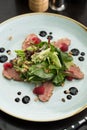 Green salad with pine nuts, meat and raspberry on the table at restaurant Royalty Free Stock Photo