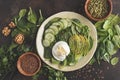 Green salad with spinach, cucumber, avocado, egg, flax and pumpkin seed. Food background. Detox Vegetarian Healthy Food Concept.