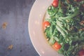 Green salad with tomatoes and pine nuts metal background