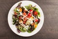 Green salad topped with beans, tomato and cheese on a plate horizontal shot Royalty Free Stock Photo