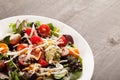 Green salad topped with beans, tomato and cheese on a plate macro shot Royalty Free Stock Photo