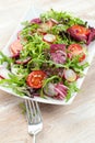 Green salat in a bowl on desk. Tomato, cheese and salad. Royalty Free Stock Photo