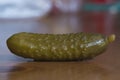 Green salted cucumber on a brown table