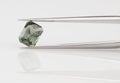 Green Sapphire Held in Gemstone Tweezers