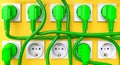 green Schuko plugs and yellow wall Royalty Free Stock Photo