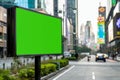 Green screen billboard on city street with urban design Royalty Free Stock Photo