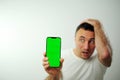 green screen chroma key phone man surprised face expression Surprised male hipster being stupefied as advertises Royalty Free Stock Photo