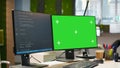 Green screen computer display in modern startup office displaying code snippets Royalty Free Stock Photo