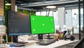 Green screen computer display in modern startup office displaying code snippets Royalty Free Stock Photo