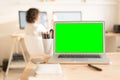 Green screen laptop computer and glass with pencils on table Royalty Free Stock Photo