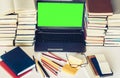 Green screen laptop, stack of books, notebooks and pencils on white table, education office concept background Royalty Free Stock Photo