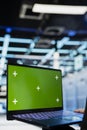 Green screen laptop used by data center engineer to review equipment diagnostics Royalty Free Stock Photo