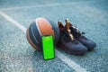 Green screen phone mock up with tracking markers, basketball ball, sports shoes for training. Chroma key, copy space