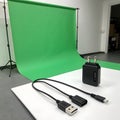 Green screen setup with usb cables and power adapter Royalty Free Stock Photo