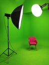 A green screen studio with complete lighting equipment. With a red chair in the middle